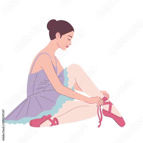 Young ballerina in a purple tutu sitting and tying her pink ballet pointe shoes