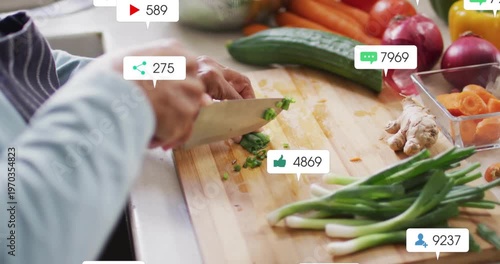 Home cook slicing green onions and causing social media icons emerging showing food engagement rise