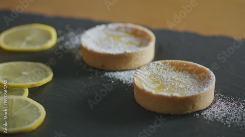 Wallpaper Mural Lemon tarts dusted with powdered sugar on a black slate. Torontodigital.ca