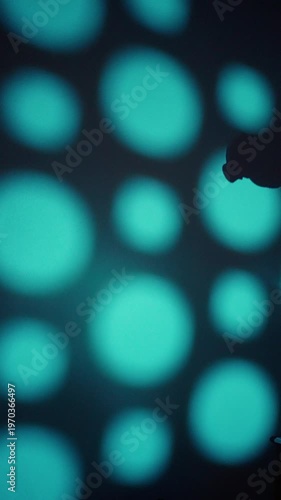 Silhouette Practicing Tennis Swing. Player Silhouette Performing Controlled Tennis Swing. Neon Bokeh Backdrop With Player Silhouette Executing Slow Motion Controlled Tennis Strokes