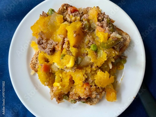 Leftover homemade cottage pie and vegetables on toast for an afternoon warm snack
