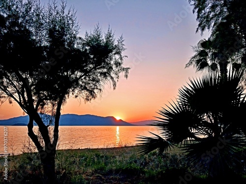 Greece - view of sunrise from the coast near the town of Kamena Vourla