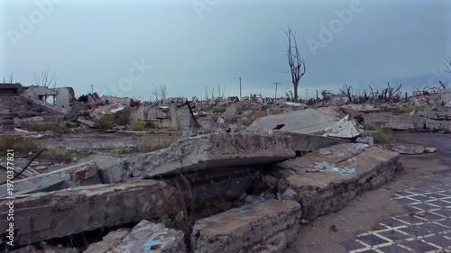 Drone flight from inside a construction until revealing the magnitude of damage in Villa Epecuen. Stormy, gloomy, and devastating atmosphere.