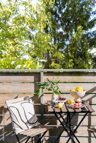 Bright balcony setting with fruit and flowers for morning relaxation