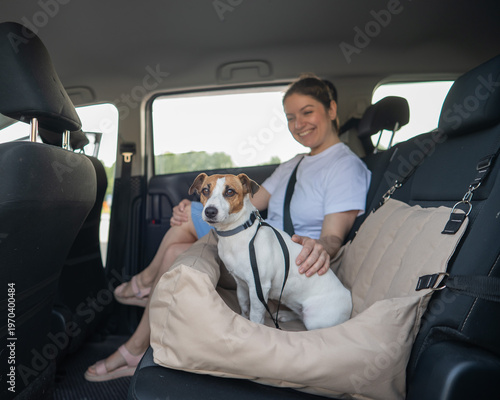 Obraz na płótnie Caucasian woman travels by car with her dog