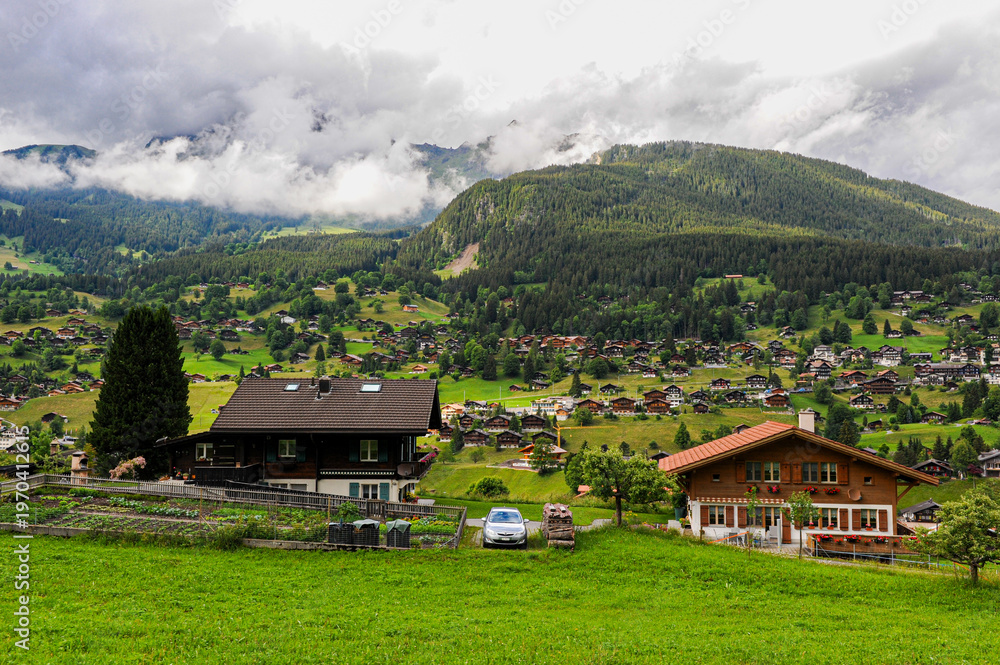 Fototapeta premium Panoramic view of Grindelwald village houses on the hillside 