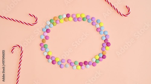 Candy and Lollipop Frame on Pastel Orange Background Flat Lay Stop Motion Sweet Creative Copy Space 4K