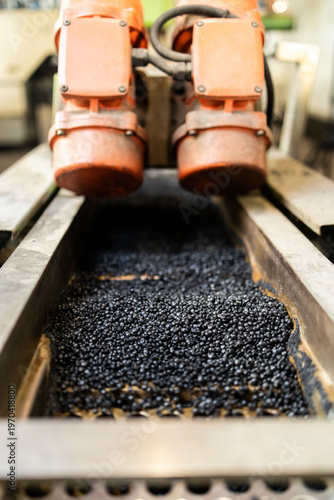 Recycled plastic pellets moving on production line conveyor