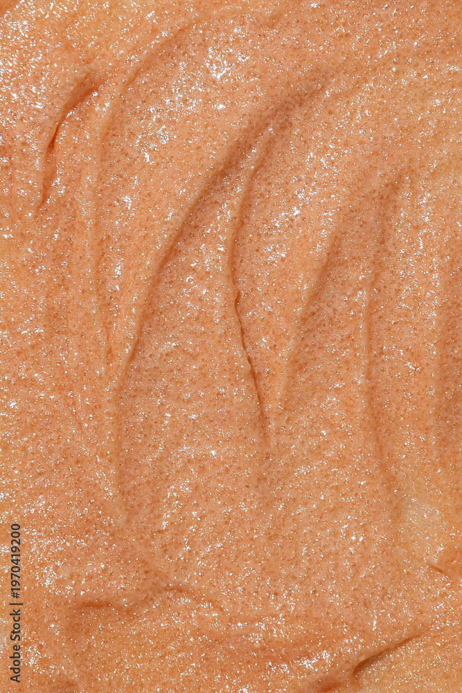 Fototapeta premium Close-up macro texture of shimmering beige cosmetic scrub with fine particles