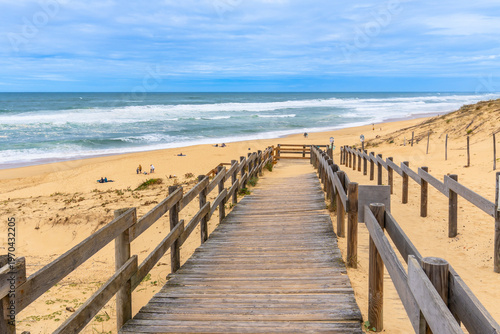 Wooden boardwalk leading to messanges beach in landes, france