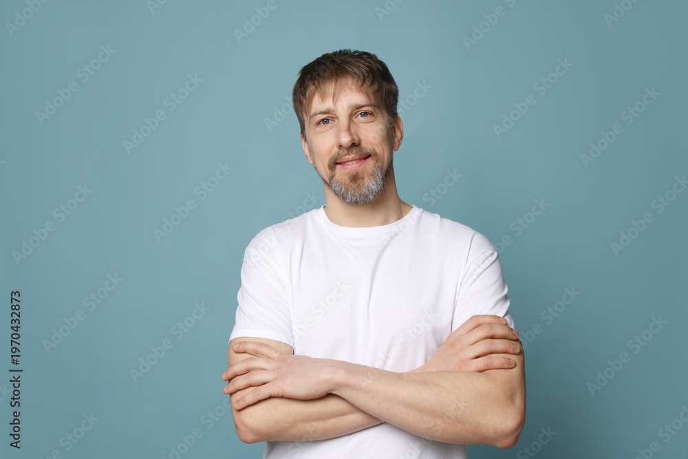 Fototapeta premium Portrait of handsome man on light blue background