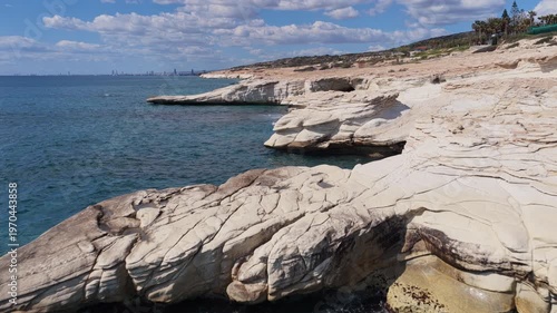 Aerial drone view of white cliffs meeting turquoise water near Ayia Napa, Cyprus