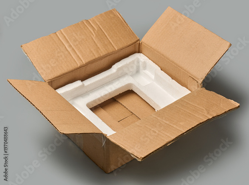 Fotografie empty open brown cardboard box with styrofoam isolated grey background, containe