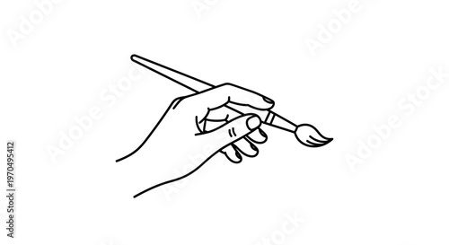 Hand holding paint brush tightly.