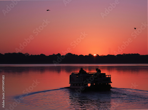 Fishermen Head Out in Their Pontoon Boat as The Sun Rises on the Lake