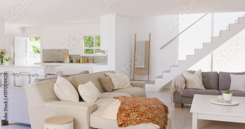 Camera starting right pan revealing beige sofa at home with rust-throw, coffee-table showing style