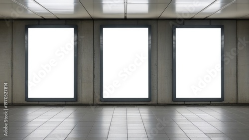 Three blank vertical digital billboards with bright white screens providing ample customizable space for advertising mockups in an underground station.