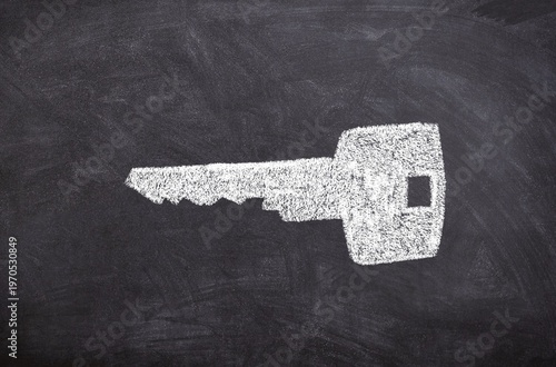 Hand drawn chalk sketch on blackboard with a key symbolizing access security and doors