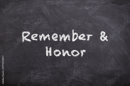Hand drawn chalk sketch on blackboard with the text Remember and Honor for Veterans Day symbolizing respect remembrance and gratitude toward veterans