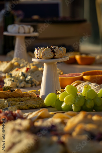 Photos Lavish charcuterie board and grazing table with cheeses, fruits, and cold cuts