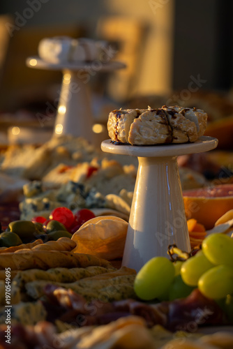 Lavish charcuterie board and grazing table with cheeses, fruits, and cold cuts.