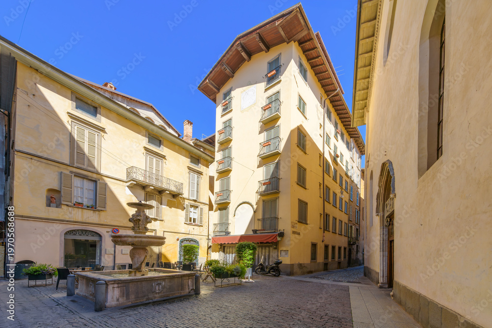 Obraz premium The Fontana del Gombito, a historic stone fountain on the main street of Via Gombito in the Città Alta Upper Town of Bergamo, Italy