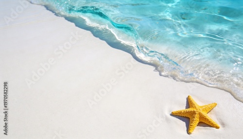 Yellow starfish on white sand beach with clear turquoise ocean wave
