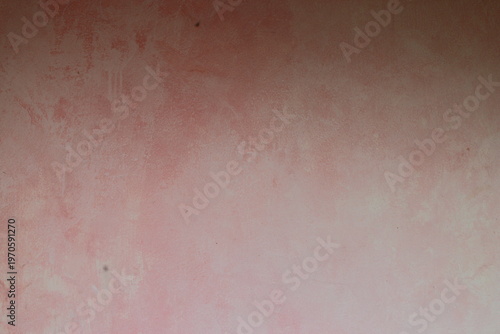 Soft pink plaster wall texture background with subtle painted gradient