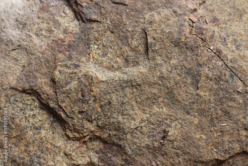 Title: Macro texture of rough brown weathered rock surface with natural stone grain   