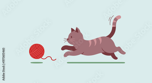 Playful Cat Chasing a Ball of Yarn