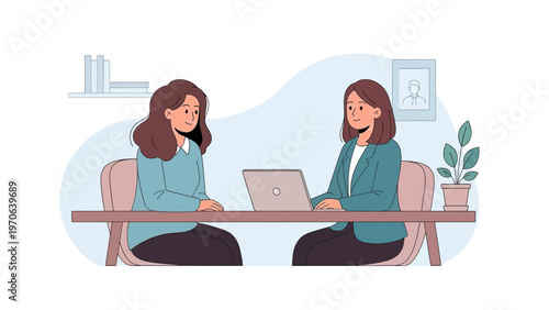 Two women in business meeting, one interviewing the other with laptop on table