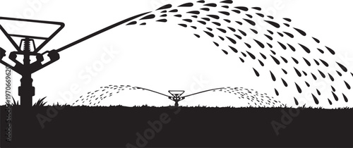 Silhouette of irrigation system watering a field at night time