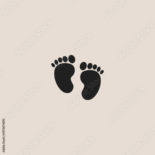 Soft beige background holds simple black footprints. Tiny toes and soles show a child's innocence. Calm image conveys tender new beginnings. Ideal for baby, parenting, or family themes