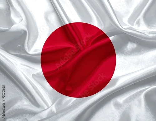 A crimson circle on a wavy silver fabric background