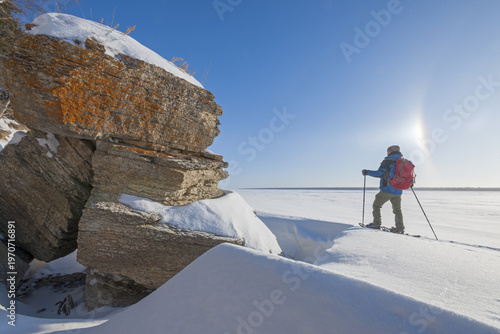 Bild auf Leinwand snowshoeing  along  cliffs, ice crystals in the air, Hecla/Grindstone Provincial