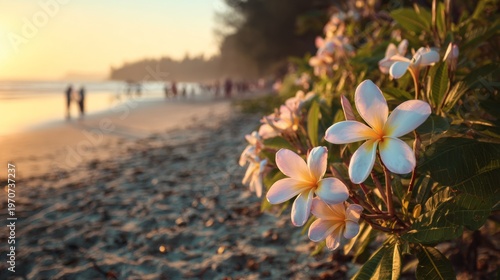 Plumeria flowers resting on sandy tropical beach at sunset with warm golden sunlight, gentle ocean waves and soft silhouettes of people in the background, peaceful seaside travel destination with sere