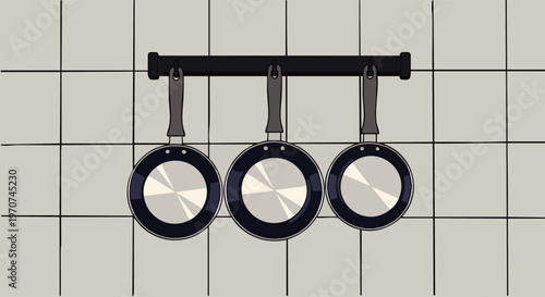 Three black frying pans hanging on a dark rack against a light tiled kitchen wall, minimalist illustration of cooking utensils.