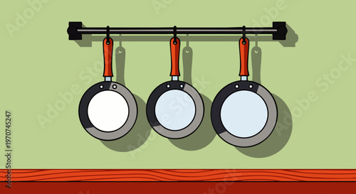 Cartoon illustration of three frying pans with red handles hanging on a black rack against a light green kitchen wall. Essential kitchenware.
