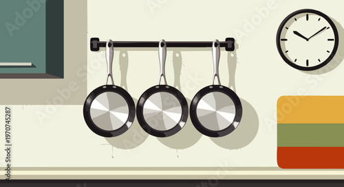Three shiny frying pans hanging on a rack in a modern kitchen, with a clock on the wall and a colorful cabinet in the background.