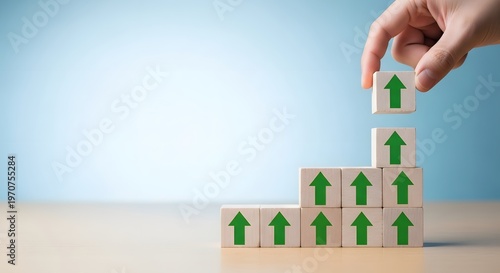 Building success hand placing block on growing stack with upward arrows