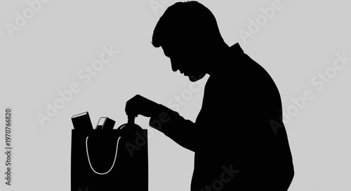 Man in silhouette rummages through shopping bag on gray background
