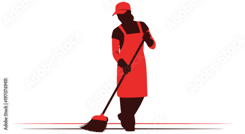 Man in red apron and cap sweeping floor with broom in hand industrially