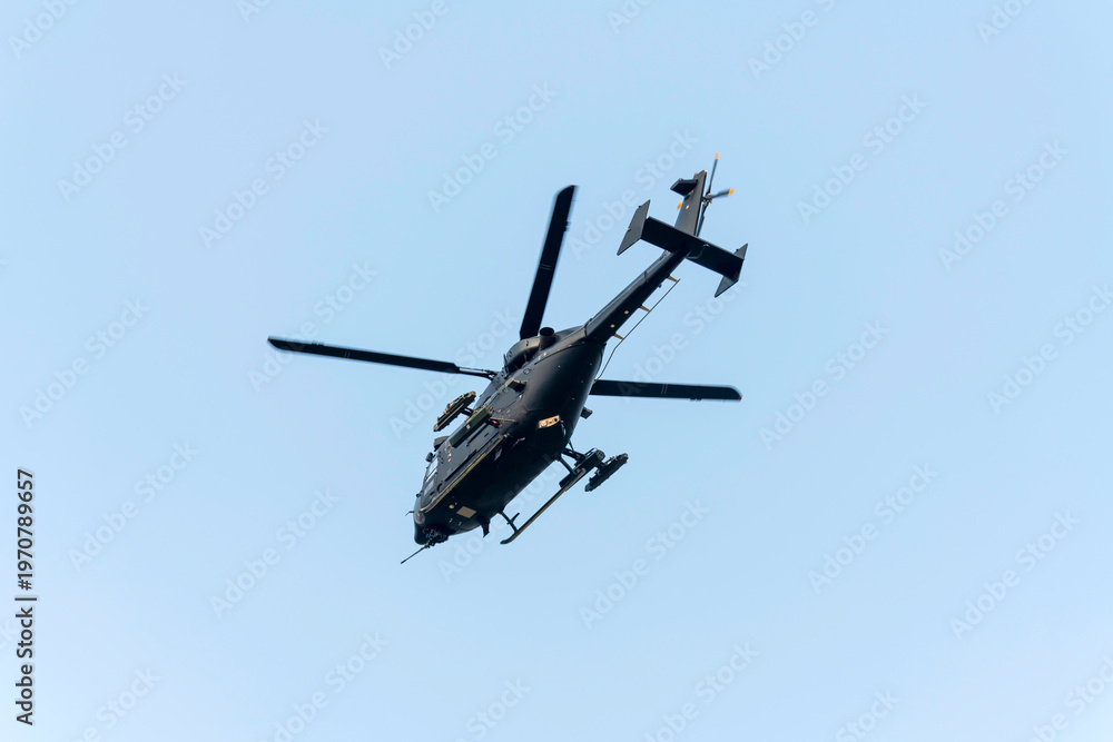 Fototapeta premium Helicopter is flying over isolated blue sky 
