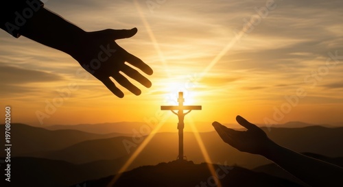 A silhouette of two hands reaching out towards a crucifix at sunset on a mountain