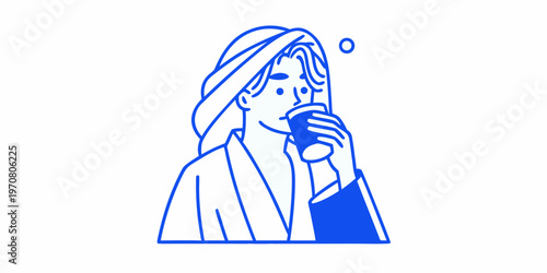 Woman enjoying a hot beverage while wrapped in a cozy bathrobe