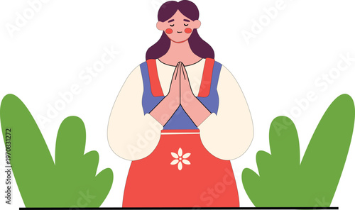 Woman in traditional dress praying with hands together in garden