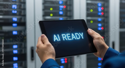 A person holding a tablet with AI Ready displayed on the screen in front of server racks
