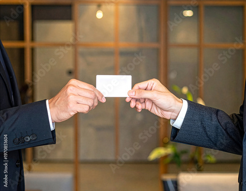 Close-up of Japanese business people exchanging business cards with respect, professional etiquette, copy space