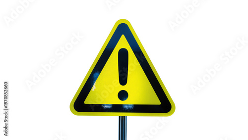 Yellow triangular warning sign, black exclamation mark symbol on metal post