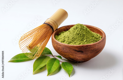 Premium Organic Matcha Green Tea Powder in Wooden Bowl with Bamboo Whisk and Leaves